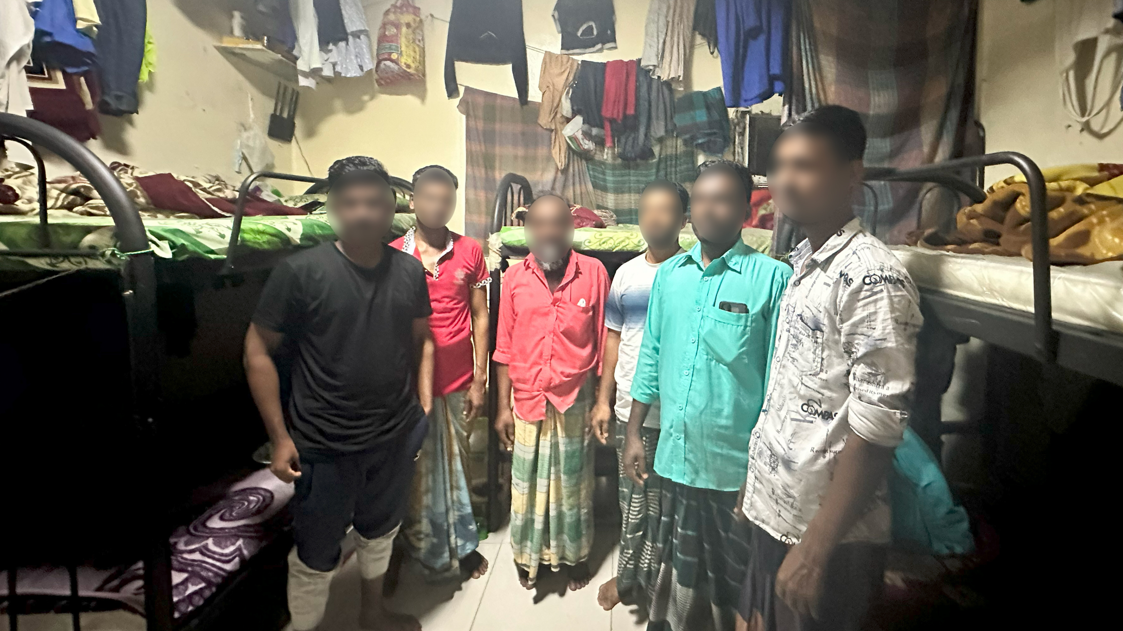 Photo of a group of migrant workers with their faces blurred for security purposes.