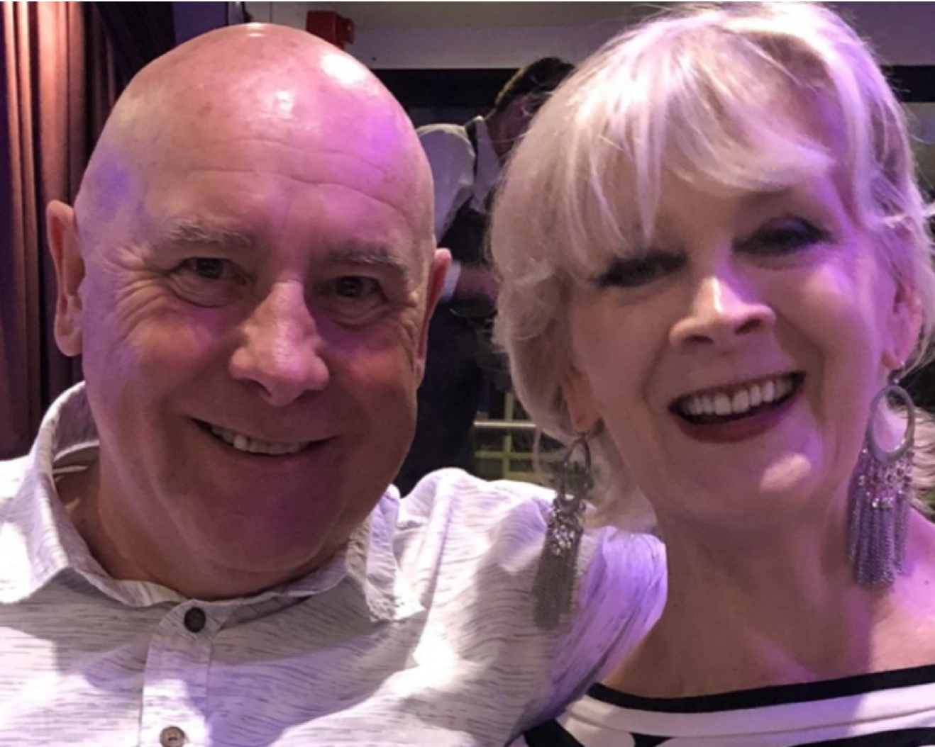 couple smiling in front of camera
