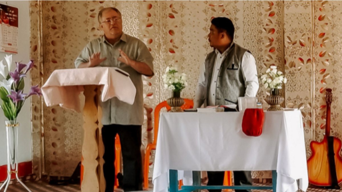 photo of two men on ministry stand preaching/speaking.