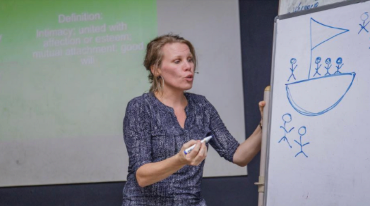 photo of woman drawing on a white board