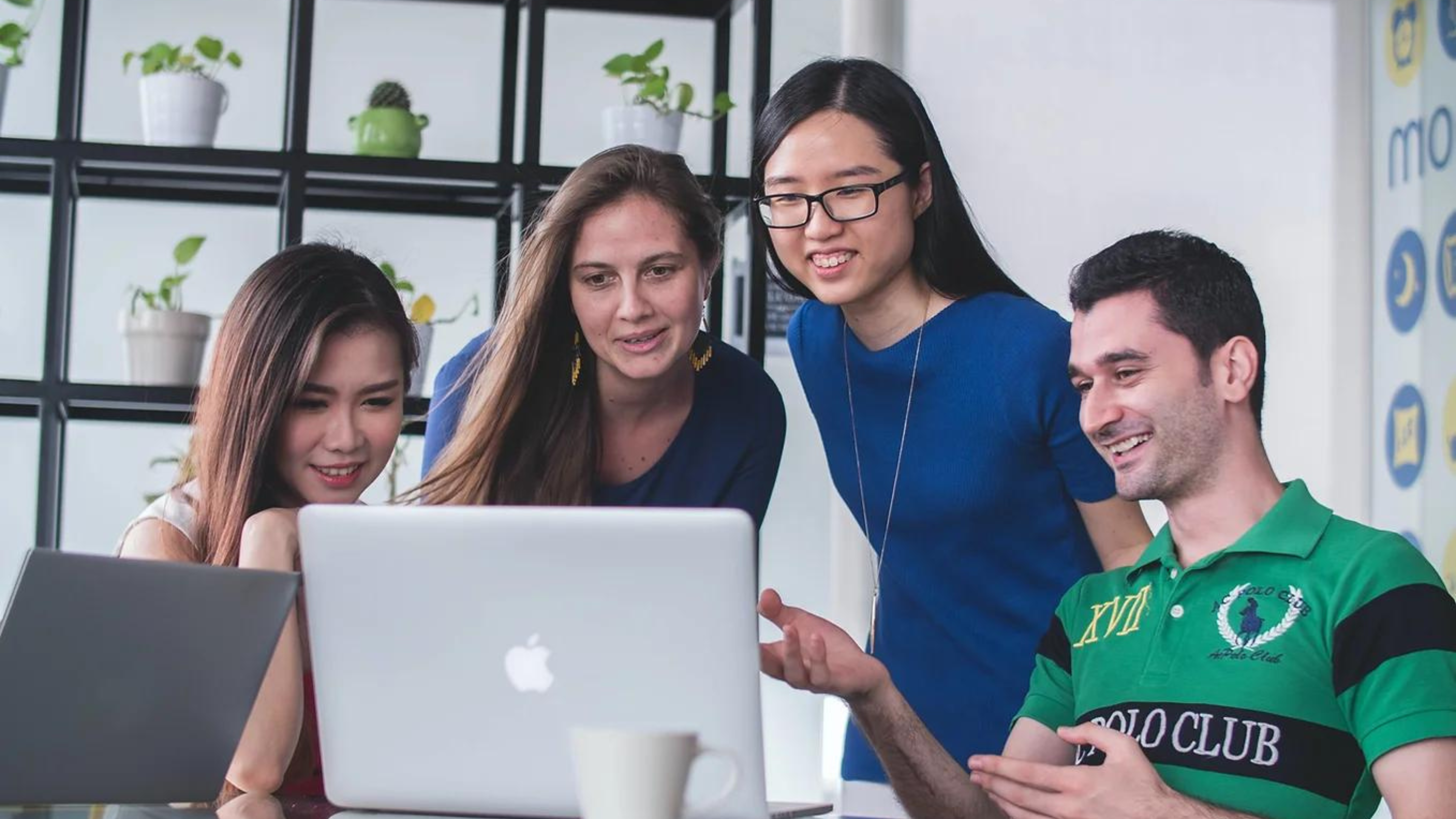 Group of teens looking on a computer together