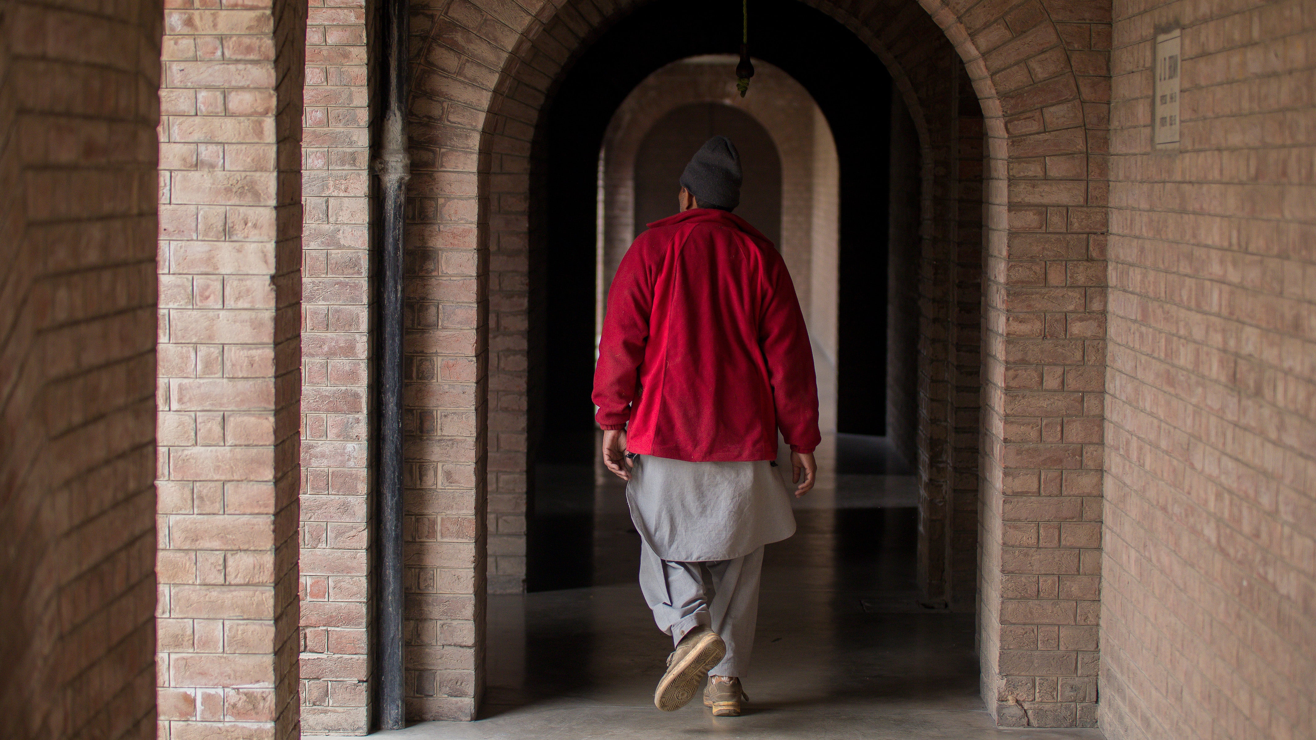 man walking through hallway