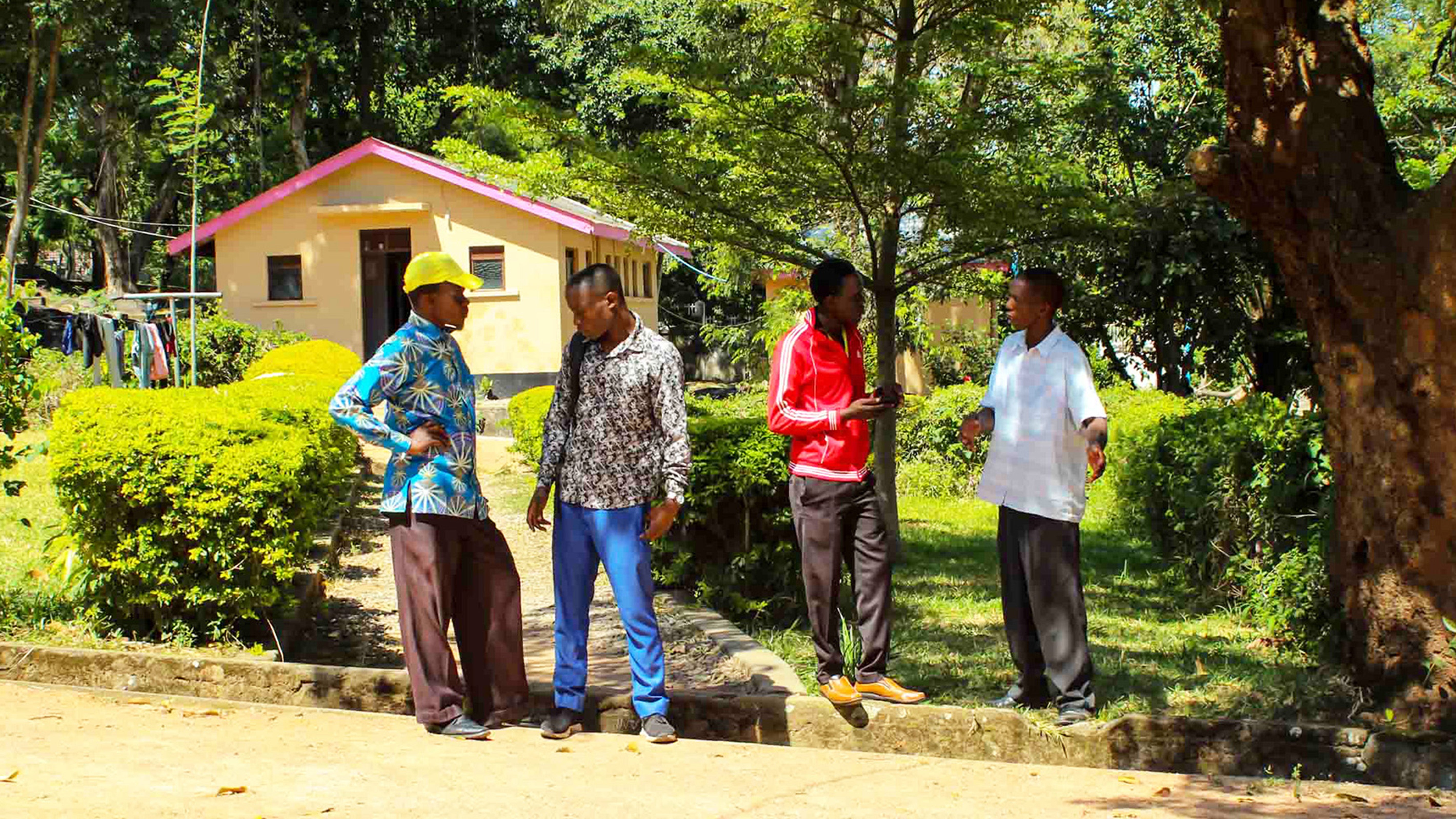 young men talking outside scenery